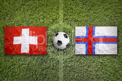 Switzerland vs. Faroe islands flags on soccer field