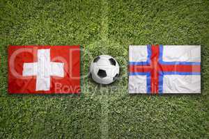Switzerland vs. Faroe islands flags on soccer field
