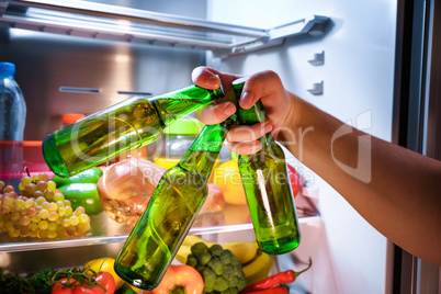 Man taking beer from a fridge