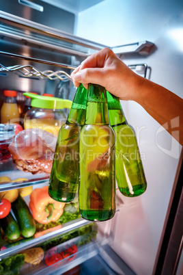 Man taking beer from a fridge