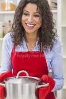 Happy Woman Holding Cooking Pot in Kitchen