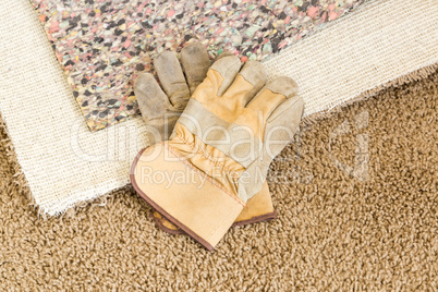 Gloves On Pulled Back Carpet and Pad In Room