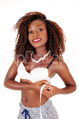 Black woman measuring breast's.