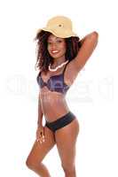 A black woman in bra and straw hat.