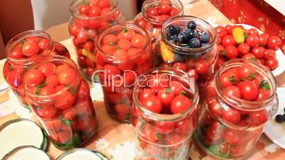 cherry tomatoes in the jars prepared for preservation