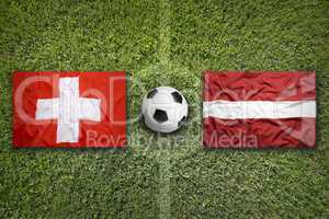 Switzerland vs. Latvia flags on soccer field