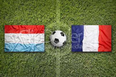 Luxembourg vs. France flags on soccer field