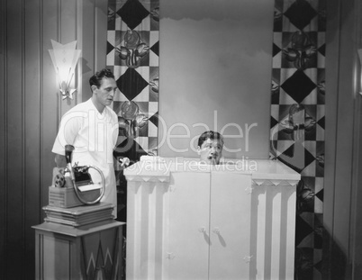 Man in steam bath with assistant and dictaphone