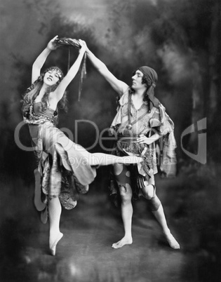 Male and female ballet dancers performing in costume