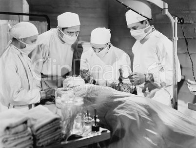 Group of doctors performing surgery