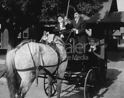Gentlemen driving carriage with horse hitched backwards