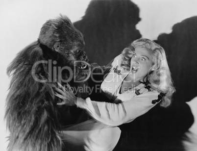 Terrified woman being attacked by gorilla