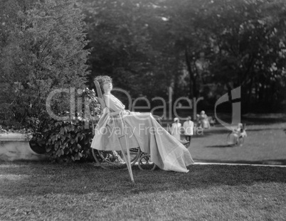 Female patient in wheelchair relaxing in garden