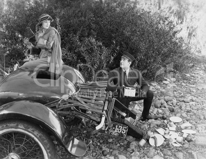 Woman and chauffer after car accident in country