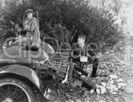 Woman and chauffer after car accident in country