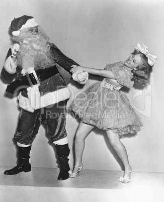 Woman trying to dance with Santa Claus