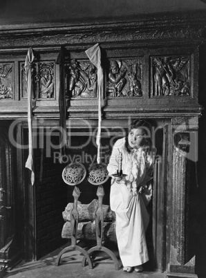 Woman with stockings hanging on hearth
