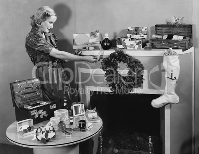 Woman with Christmas presents on mantle