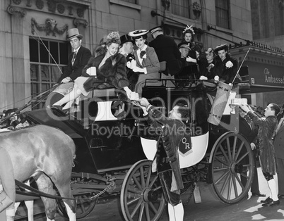 Wealthy group of people in horse drawn carriage