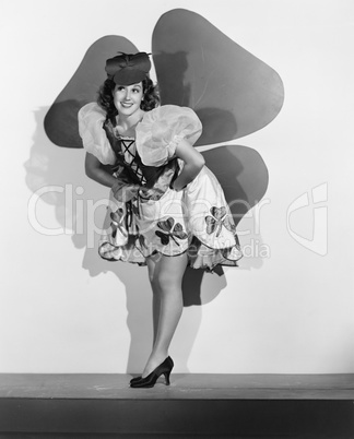 Woman posing in front of large shamrock