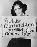 Portrait of woman holding sign written in German