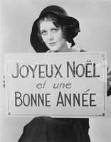 Portrait of woman holding sign written in French