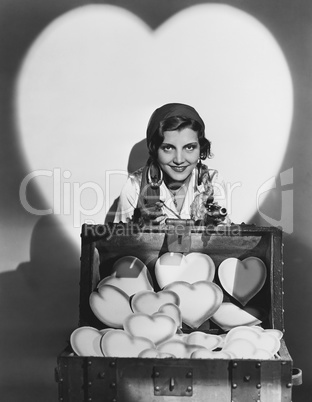 Portrait of woman with trunk full of hearts