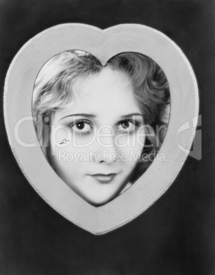 Womans face framed by heart