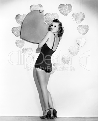 Portrait of woman holding large valentine