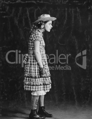 Portrait of girl in plaid dress and straw hat