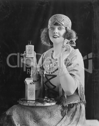 Portrait of woman using beauty product