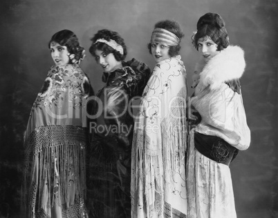 Portrait of four young women posing in shawls