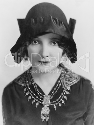 Portrait of woman wearing hat and necklace