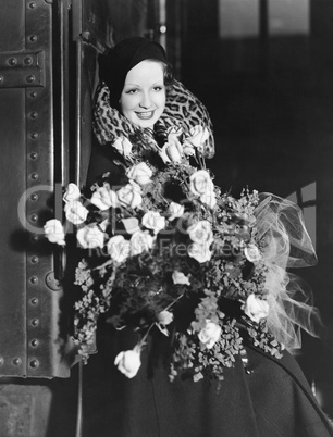 Portrait of woman with huge bouquet