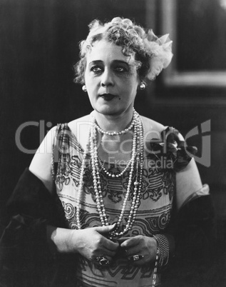 Portrait of woman wearing several necklaces