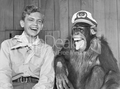 Laughing boy scout and monkey wearing hat