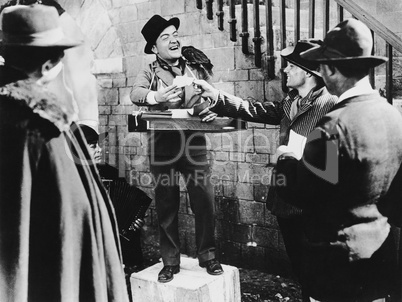 Smiling man taking bets in the street