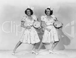 Women in matching outfits playing drums