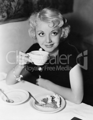 Portrait of woman having pie and coffee