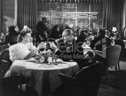 Couple dining in crowded restaurant