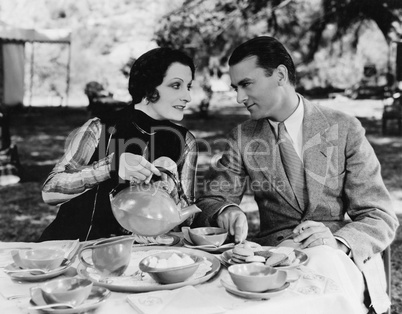 Couple having tea outdoors