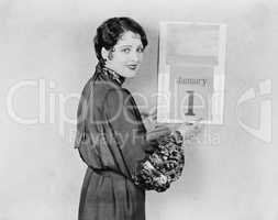 Woman with calendar on New Years Day