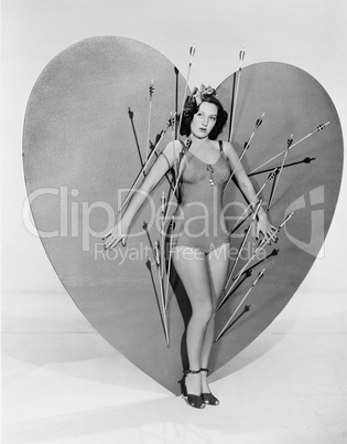 Woman surrounded by arrows on huge heart