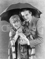 Portrait of couple under umbrella
