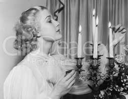 Portrait of woman lighting candles