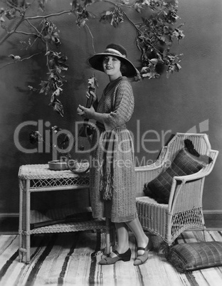 Portrait of woman indoors holding tennis racket