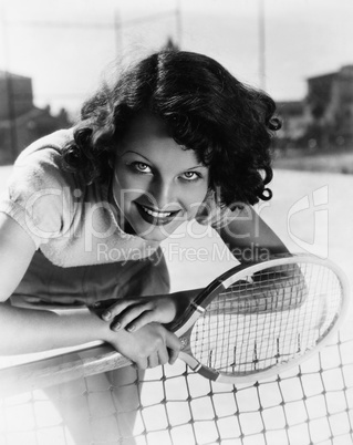 Portrait of female tennis player at the net