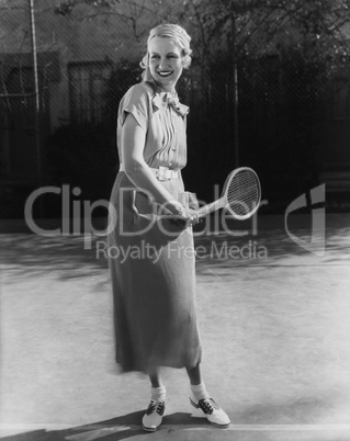 Smiling woman playing tennis