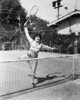 Female tennis player reaching for shot