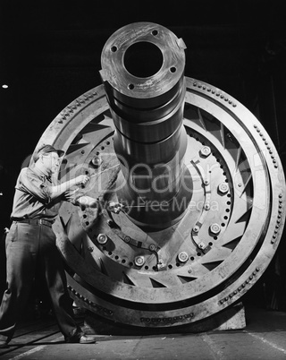 Male worker with massive machinery